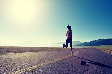 Woman jogging on a desert highway