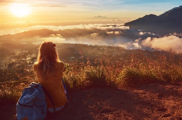 woman watching sunset over hills