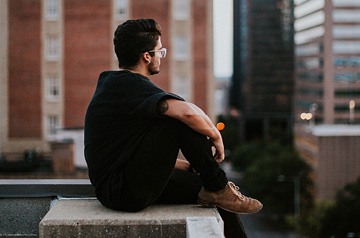 sitting on edge of building roof