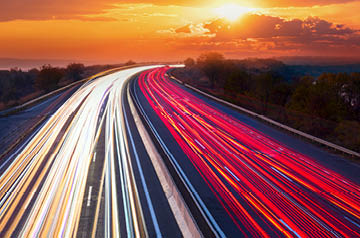 Sunset overlooking fast-moving freeway