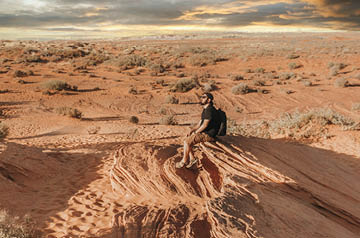 Person sitting in desert