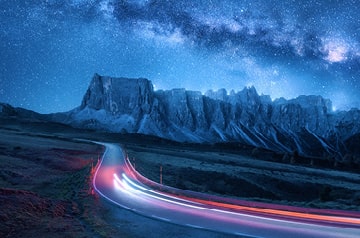 car moving quickly along a remote highway at twilight