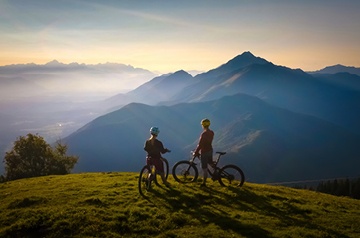 Two bikers looking at the mountains