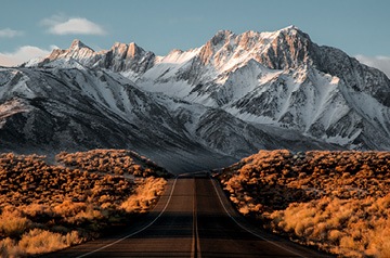 Highway leading to snowy mountains