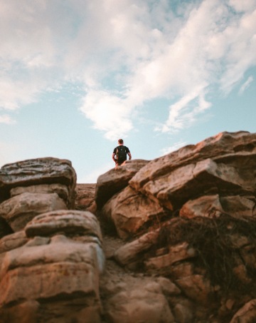 Man on top of tall rock