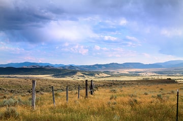 Looking across open prairie to mountain range