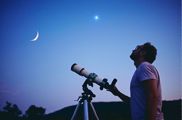 Person using telescope