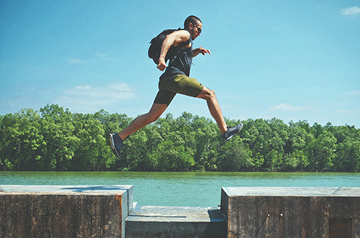 A man jumping across a gap