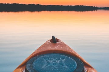 A canoe on the water at sunset