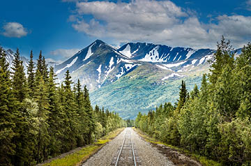 Train tracks leading toward mountains