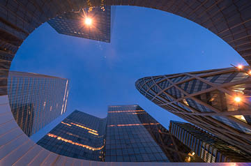 Looking towards the sky surrounded by skyscrapers