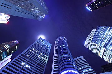 Nighttime cityscape with purple sky and brightly lit buildings