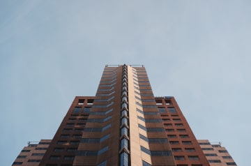 Skyscraper building, angled up toward the sky.