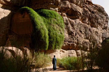 Person at foot of cliffside