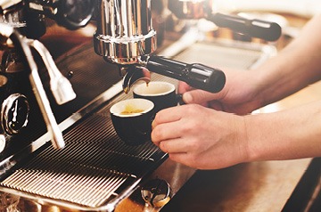 Barista pulling espresso shots